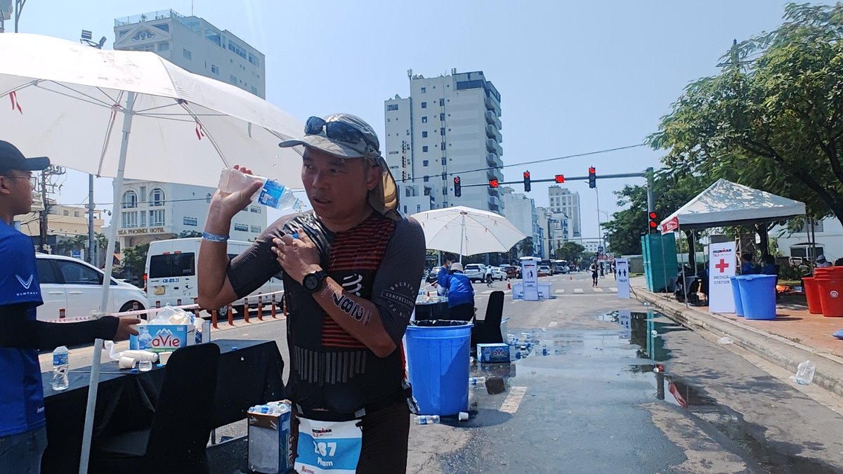 Phạm Tiến Dũng tiếp nước tại trạm giữa chặng Ironman 70.3 Đà Nẵng tháng 5/2023